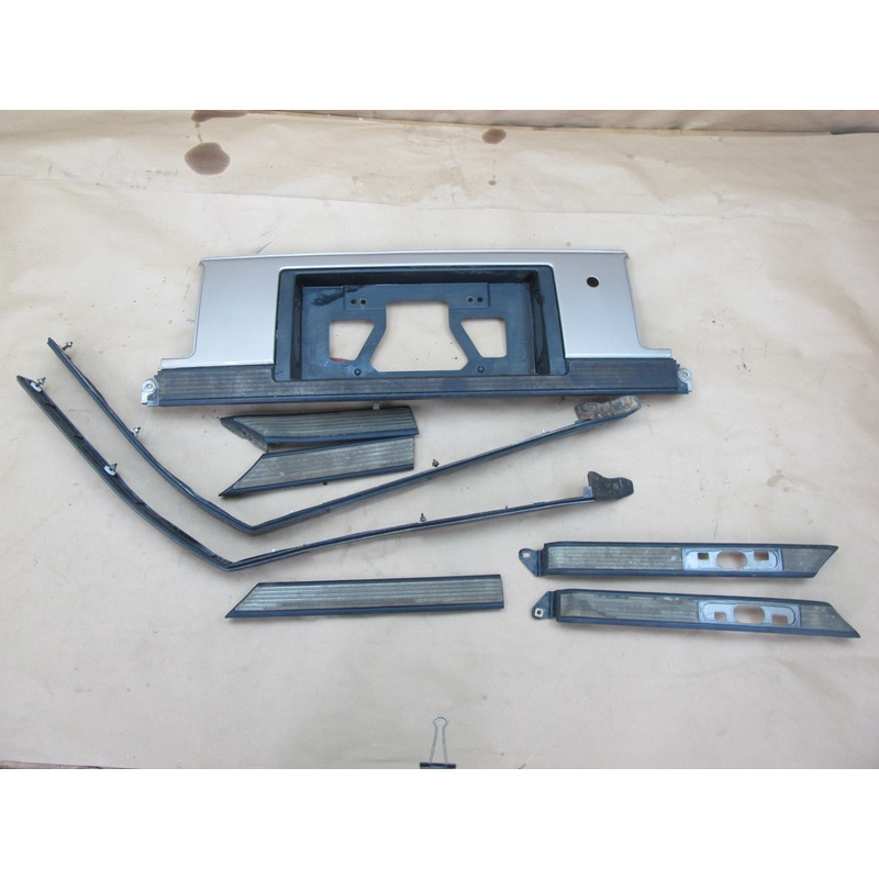 86-88 Toyota Supra A70 MK3 Rear License Plate Trim Molding Set Brown OEM